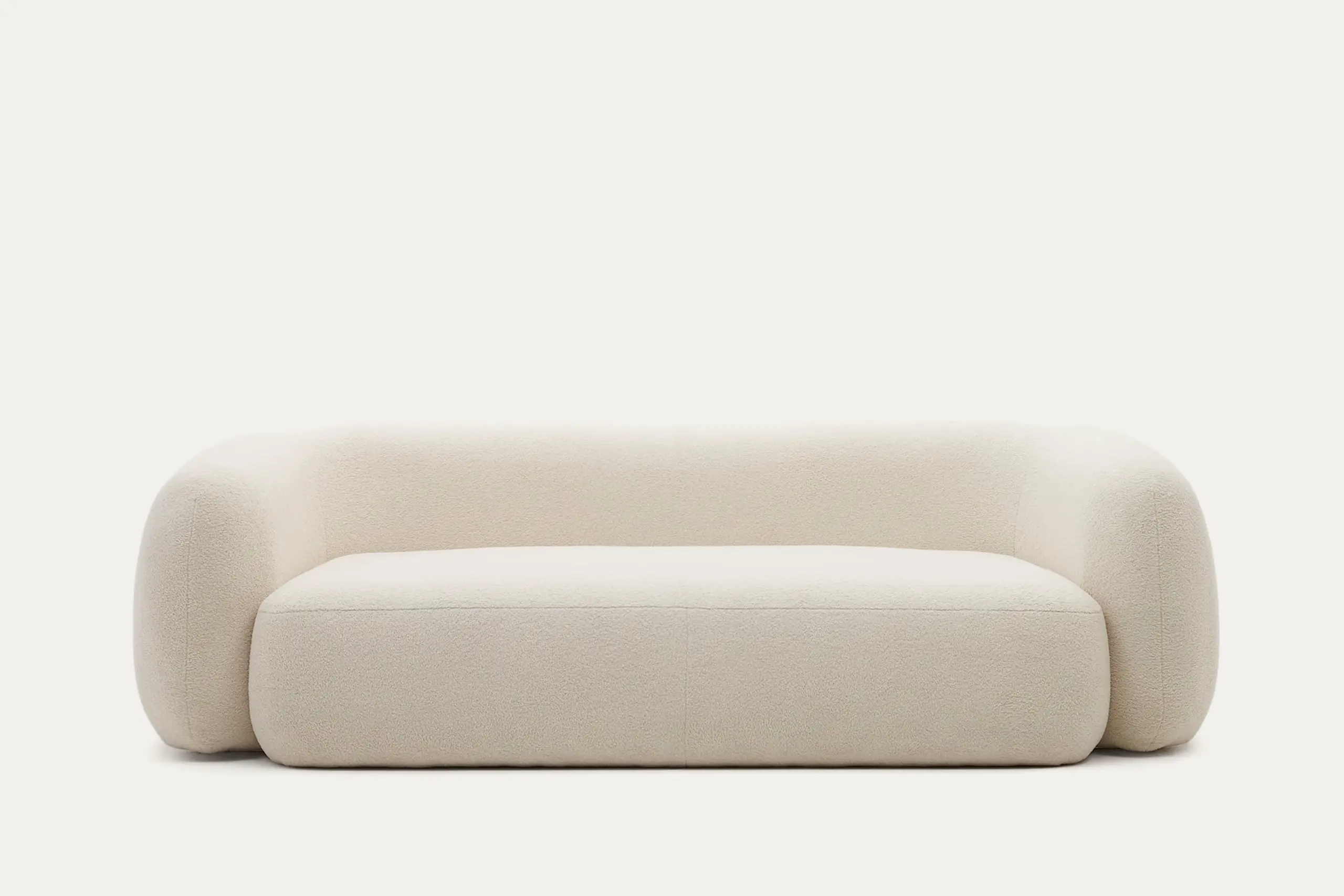 Modern cream boucle fabric sofa with rounded edges and textured surface, isolated on white background for luxury furniture stores in Sri Lanka.